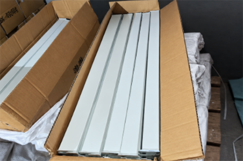Metal retail display stand components prepared for carton packaging